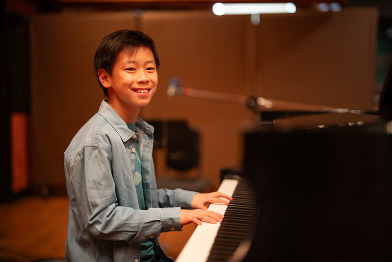 Boy smiles at piano