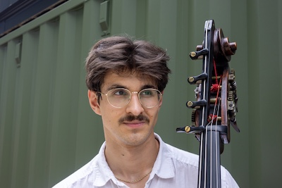 Christian Luevano holds double bass