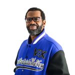 man looks at camera in front of white background